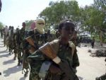 A young boy leads the hard-line Islamist al-Shabab fighters as they conduct military exercise in northern Mogadishu’s Suqaholaha neighborhood, Somalia, Jan. 1, 2010