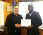 UNWTO Executive Director Member Relations and Services Zoltan Somozyi (right) presenting an honourary certificate to First Secretary for Tourism Percy Ngwira, in Madrid on Thursday. – Picture courtesy of the Zambian Embassy.