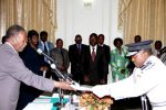 President Michael Sata receives the Affidavit of Oath from State House Commissioner of Police Godwin Phiri during the swearing -in-ceremony at State House on February 12,2014 -Picture by THOMAS NSAMA