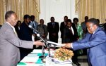 President Michael Sata receives the affidavit of Oath from Special Policy Analysist and Coordination Division, Cabinet office Robert Kasezya during the swearing -in-ceremony at State House on February 12,2014 -Picture by THOMAS NSAMA