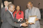 ZAMBIA Daily Mail news editor Newton Sibanda reaches out for his certificate from Archbishop of Lusaka Telesphore Mpundu during the 2014 Media Institute of Southern Africa (MISA) Zambia media awards