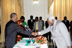 Ambassador Mumba Kapumpa who has been sent to South Korea, shakes hands with President Sata
