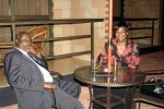 Lameck Mangani having a drink with former Lands Minister Judith kapijimpanga – Photo Credit –  thepicturemonger