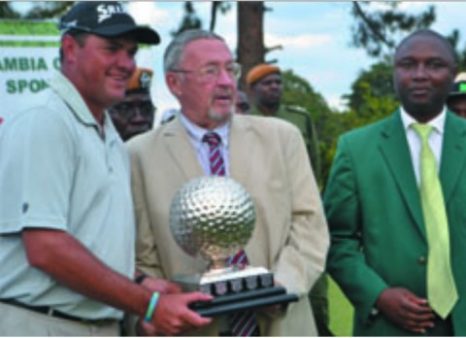 MOPANI Copper Mines 2014 Zambia Open Champion Willie Coetsee of South Africa hoists the trophy after it was presented to him by Vice-President Guy Scott (centre) - lusakavoice.com