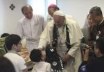 Pope Francis blesses a disabled child during his visit to the rehabilitation center for disabled people at Kkottongnae in Eumseong, August 16, 2014.