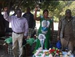 Secretary General Wynter Kabimba, Zambezi West PF candidate Christabel Ngimbu and her campaign manager Wilbur Simuusa sing the national anthem at a meeting