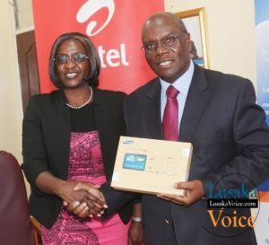 Airtel CEO Charity Chanda Lumpa and Zambia Open University Vice Chancellor Professor Mutale Musonda showing off a tablet; Airtel and ZAOU have launched a loan Scheme that will enable the ZOAU members of the Senate to acquire tablets that they will be paying monthly, the ceremony took place at ZOU senate boardroom off Mumbwa road in Lusaka West on Wednesday, September 24th, 2014.