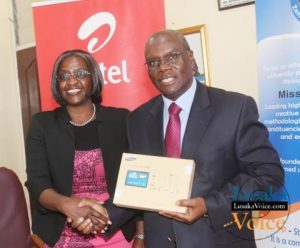 Airtel CEO Charity Chanda Lumpa and Zambia Open University Vice Chancellor Professor Mutale Musonda showing off a tablet; Airtel and ZAOU have launched a loan Scheme that will enable the ZOAU members of the Senate to acquire tablets that they will be paying monthly, the ceremony took place at ZOU senate boardroom off Mumbwa road in Lusaka West on Wednesday, September 24th, 2014.