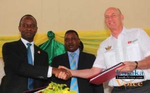 The Lusaka City Mayor Mulenga Sata exchanging documents with the ZANACO MD Dick Bruce while looking on is Deputy Minister of Local Government and Housing Nicolas Banda during launch between Zanaco and Lusaka City Council Direct Debit and Credit Clearing (DDACC) at the Nkatindi Hall