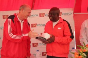 Zanaco MD Dick Bruce congratulating the PS Dr. Patrick Nkanza voted the best player
