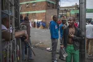 An African immigrant holds a machete in a run-down district of east Johannesburg(Siphiwe Sibeko:Reuters)