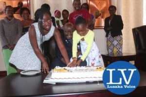 KK great grand daughters Gugu Letu Bwalya and Tiyezye Kaunda helping KK to cut a cake made for him. - Photo Credit Jean Mandela - Lusakavoice.com