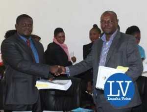 Buildcon CEO Moses Mubanga and RDA CEO Kanyuka Mumba - in a red tie- during the Chingola Solwezi Road construction Lot 2 contract signing ceremony at Mass Media area RDA offices