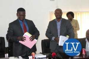 Buildcon CEO Moses Mubanga and RDA CEO Kanyuka Mumba - in a red tie- during the Chingola Solwezi Road construction Lot 2 contract signing ceremony at Mass Media area RDA offices