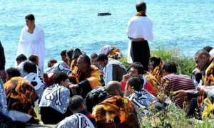 Migrants recover from their ordeal on the Rhodes seashore. Photograph- Nikolas Nanev:AP
