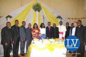 Lusaka Archdiocese Archbishop Telesphore George Mpundu ordains 11 priests at Lusaka Holy Cross Cathedral on Saturday, May 30th, 2015. Archbishop joins his newly ordained priests in cutting a cake and thereafter joined them for a family picture with Gender Minister Prof Luo Nkandu and Chiefs and Traditional Affairs Minister Joseph Katema.