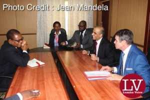 in a red tie Bharti Airtel CEO and Chairman Sunil Bharti Mittal visiting the Minister of Transport and communications Kampembwa Simbao
