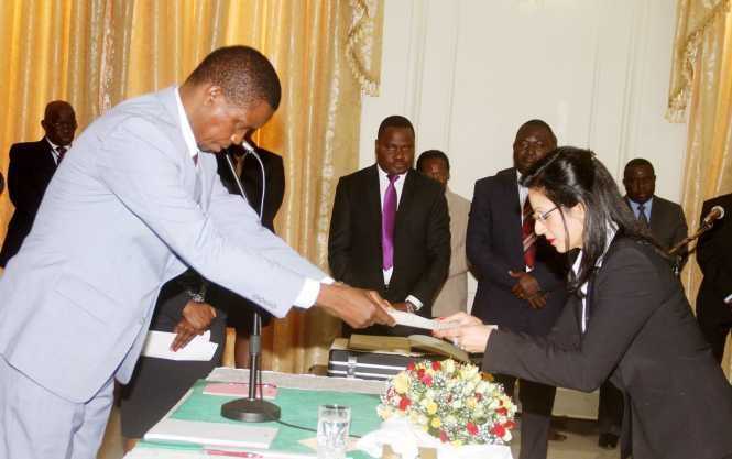 President Lungu receives an affidavit of Oath from newly appointed State Counsel Abha Nayar Patel during the Swearing-In-Ceremony at State House on Tuesday, June 14,2016