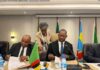 Mposha and tanzania deputy Minister sign Declaration as LTA official centre looks on