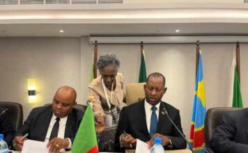 Mposha and tanzania deputy Minister sign Declaration as LTA official centre looks on